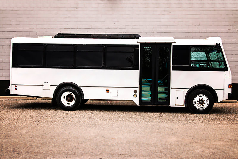 This 30 passenger white party bus exterior view looks great sitting in Grand Rapids