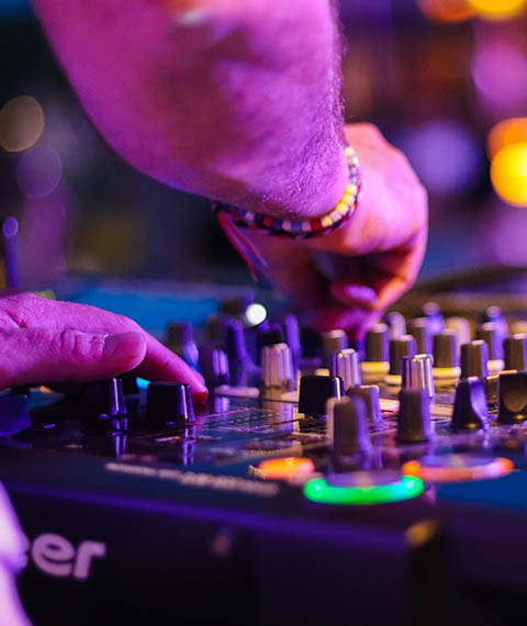 A DJ operates a sound board in Grand Rapids clubs