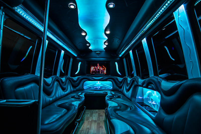 The same party bus interior accented by blue lighting.