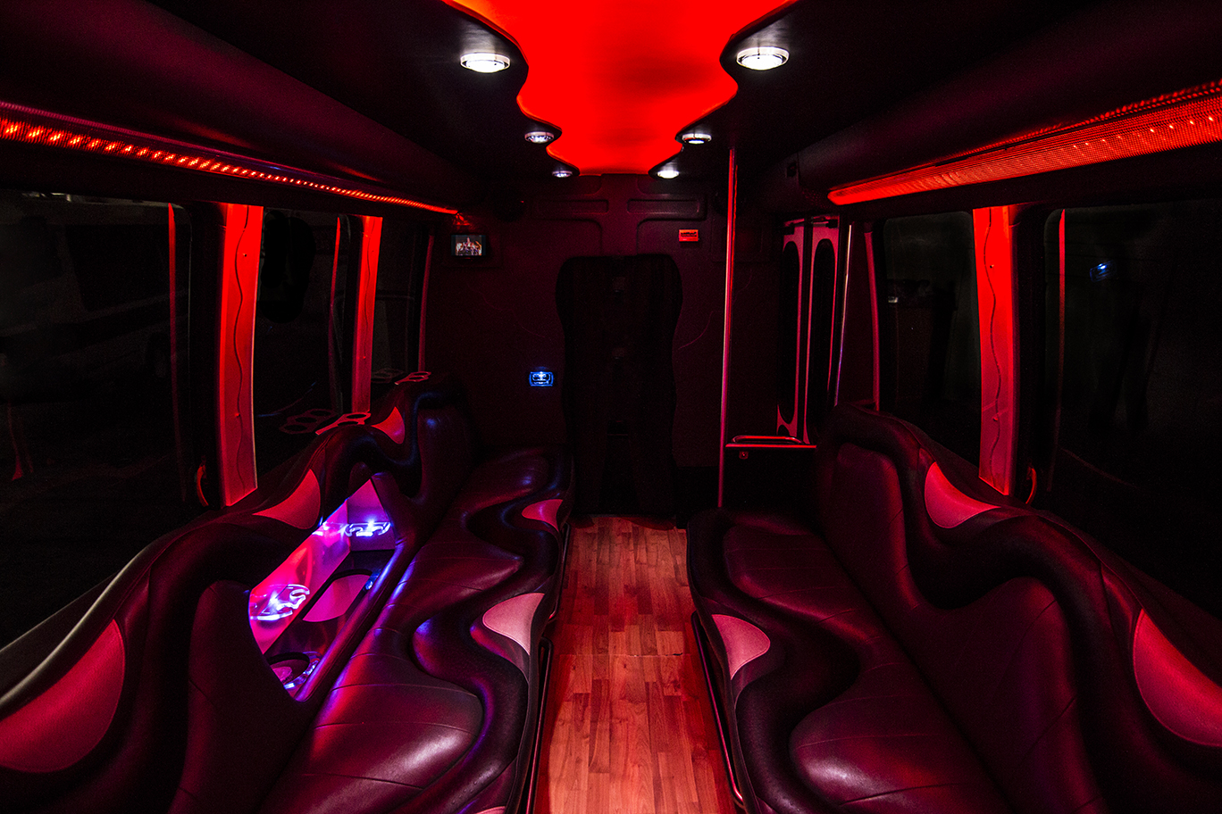 An opposite view of the 14 passenger limo bus this time with red lights.