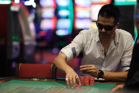 A man in sunglasses being cool on his Grand Rapids casino trip