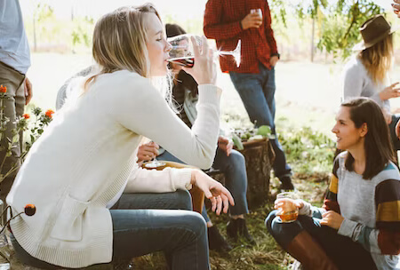 A woman enjoying a glass of wine on a West Michigan wine tour